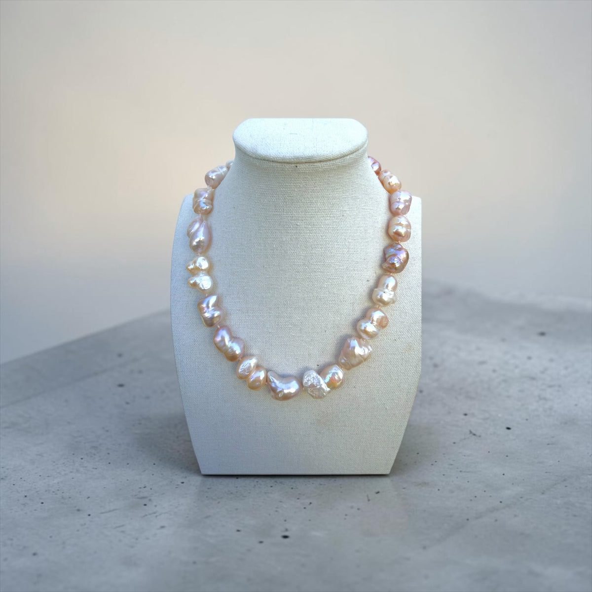 TNT Designs Jewels blush pink baroque pearl statement necklace with iridescent luster on a white display bust