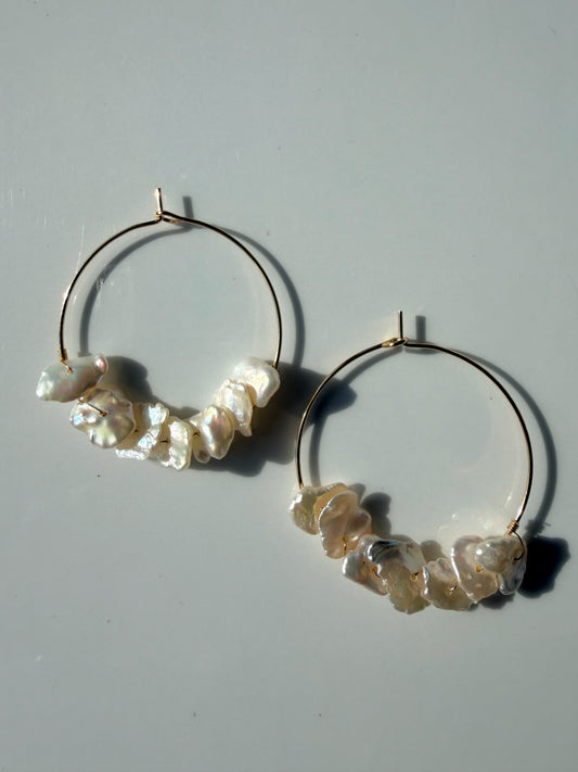 TNT Designs Jewels gold hoop earrings featuring lustrous irregular baroque pearls for a modern bohemian look.